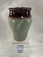 Front view of porcelain vase showing celadon body and copper red rim