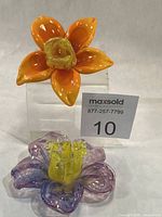 Both glass flower candle holders front view