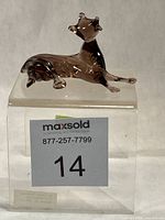 Full view of smokey glass hound on clear block