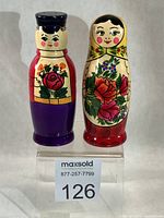 Front view of both matryoshka shakers on riser with lot number