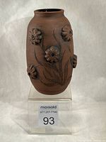 Front view of vase showing 3-D flowers and sgraffito design