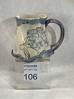 Front three-quarter view of mug showing design and scalloped base
