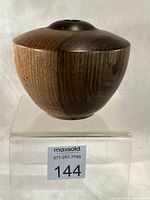 Front view of walnut turned vase on display stand