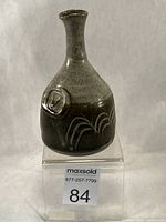 Front view showing shape, glaze and artist stamp