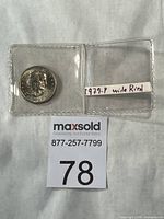 Coin in plastic flip with handwritten label 1979-P wide rim