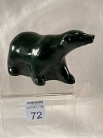Left frontal view of green stone walking bear carving