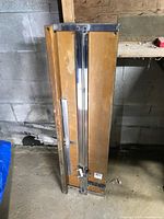 Full view of folded mat cutter leaning upright