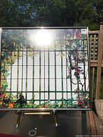 Full view of framed grape vine printed art on stand