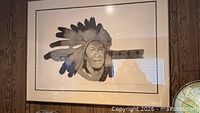 Full view of framed intaglio print showing Indigenous American chief in feather headdress