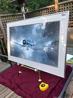 Front view of framed aviation print on stand