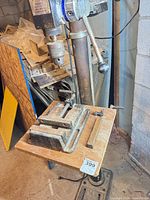 Full view of drill press with attached vise on table