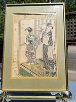 Full view of framed Utamaro woodblock print in gold frame