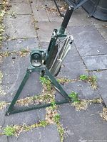 full view of manual clay pigeon launcher on stone surface