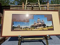 Full view of framed mosaic artwork on easel
