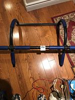 Full view of the door-mounted pull-up and dip bar showing frame and grips