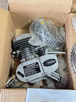 Engine kit in box showing cylinder, crankcase and bubble-wrapped parts