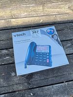 Front of retail box showing VTech CD1281 corded telephone image and features