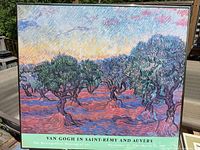 Full view of framed Van Gogh exhibition poster on table