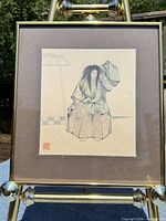Full view of framed woodblock print on easel