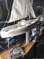 Port side view of white J/24 RC sailboat with sails raised and Challenger 250 transmitter