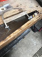 Large rip saw blade with attached jig on workbench