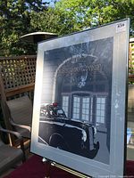 Front view of framed lithographic reproduction print showing taxi and The Ritz Restaurant facade