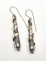 Full view pair of sterling and gold dangle earrings