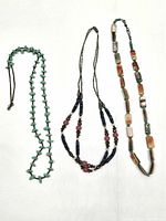 Three necklaces laid out showing overall styles and lengths