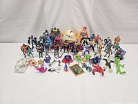 Overall lot showing all action figures, accessories and model parts on white background