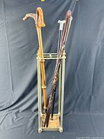 Canes in brass stand showing variety and overall condition