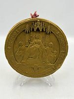 Front view of wax seal showing Queen Victoria relief and border text