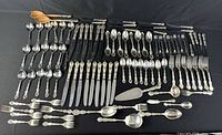 Full layout of all flatware pieces on black background