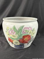 Front view of porcelain planter showing floral decoration