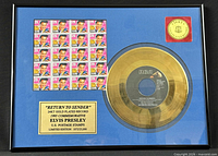 Framed display showing gold record, Elvis stamp sheet, title plaque, and 24KT seal