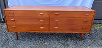 Front view of Danish teak dresser showing all six drawers closed