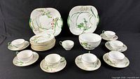 Full service layout showing cups, saucers, plates, serving pieces and bowl