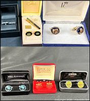 Open boxes showing eight main items: six cufflink pairs and two tie bars