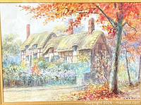 Close view of watercolour showing cottage and signature