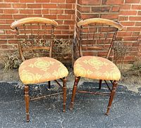 Pair of spindle back chairs front view showing design and upholstery