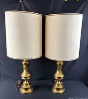 Front view of both brass table lamps with shades attached