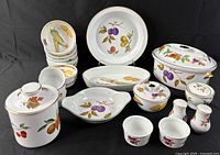 Full lot overview showing all 20 porcelain pieces with fruit motif