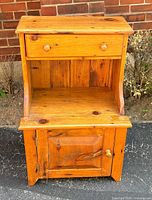 Front view showing drawer, shelf, cabinet door closed