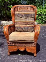 Front view of wicker arm chair with both cushions in place