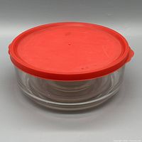 Large glass bowl with red lid