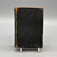 Front cover showing black leather and blind tooling