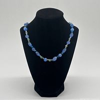 Full view of necklace on bust showing bead arrangement and length