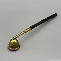 Full view of brass and wood candle snuffer showing cup and handle