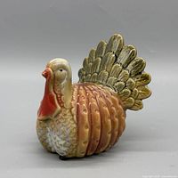 front left view of ceramic turkey figurine showing glaze and feather detail