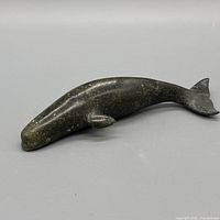 Left-side view of dark green stone whale figurine