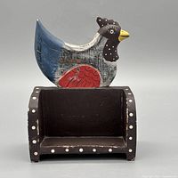 Front view of painted wooden bird holder